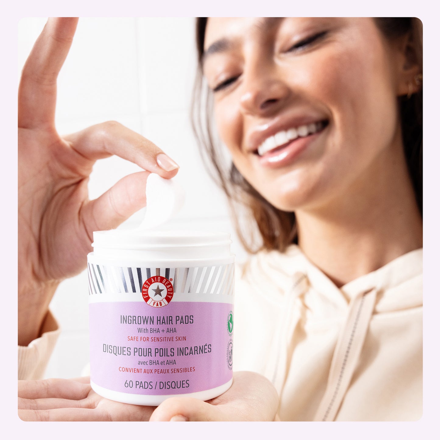 Model pulling Ingrown Hair Pad out of jar.