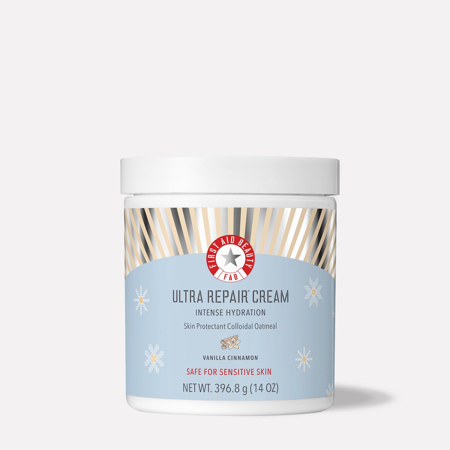 A white jar features the label "First Aid Beauty Ultra Repair Cream" with "Intense Hydration," "Vanilla Cinnamon," and "Safe for Sensitive Skin." It sits against a plain background.