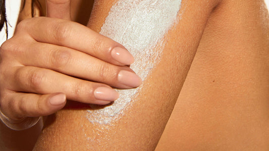 Woman with Keratosis Pilaris using KP Body Scrub on arm.