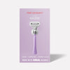 Razor displayed on purple packaging. Text reads: "FIRST AID BEAUTY rescue RAZOR. 1 Razor - 2 Cartridges - 1 Shower Holder. MADE WITH Gillette BLADES."