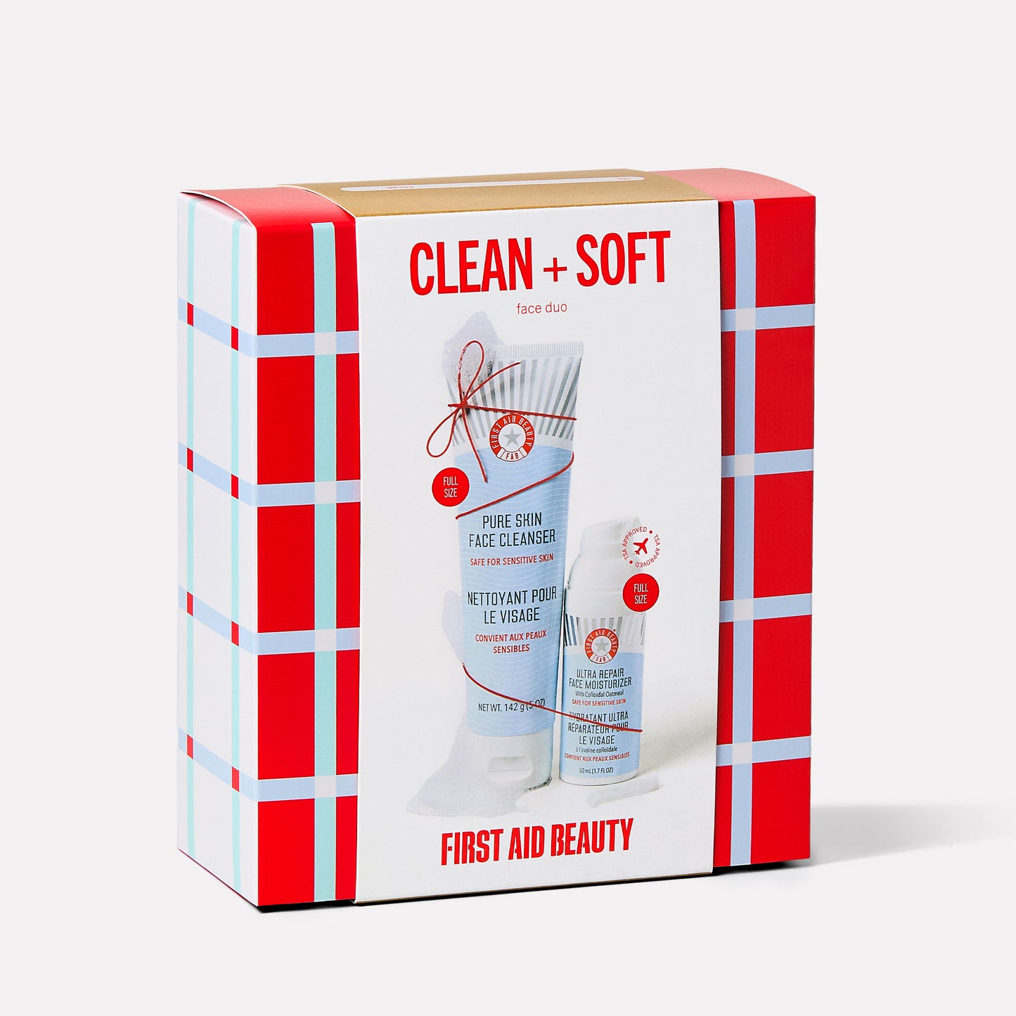 A colorful box displays skincare products. The large print reads "CLEAN + SOFT face duo" and "FIRST AID BEAUTY." The products featured are "PURE SKIN FACE CLEANSER" and "ULTRA REPAIR FACE MOISTURIZER."