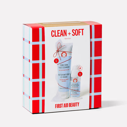 A colorful box displays skincare products. The large print reads "CLEAN + SOFT face duo" and "FIRST AID BEAUTY." The products featured are "PURE SKIN FACE CLEANSER" and "ULTRA REPAIR FACE MOISTURIZER."