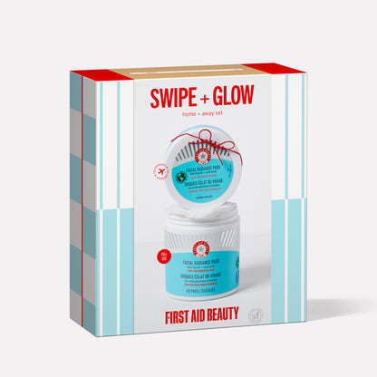 A boxed skincare set contains two jars of "First Aid Beauty Facial Radiance Pads." The label reads "SWIPE + GLOW home + away set" with blue and red accents on a white background.