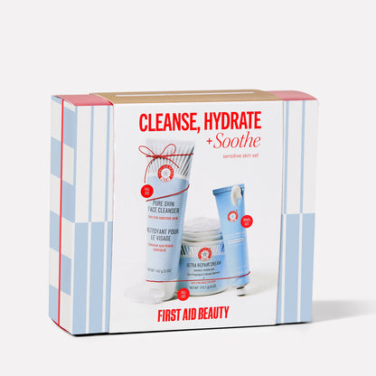 A skincare set labeled "Cleanse, Hydrate + Soothe" contains Pure Skin Face Cleanser and Ultra Repair Cream by First Aid Beauty. It’s designed for sensitive skin and includes full and travel sizes.