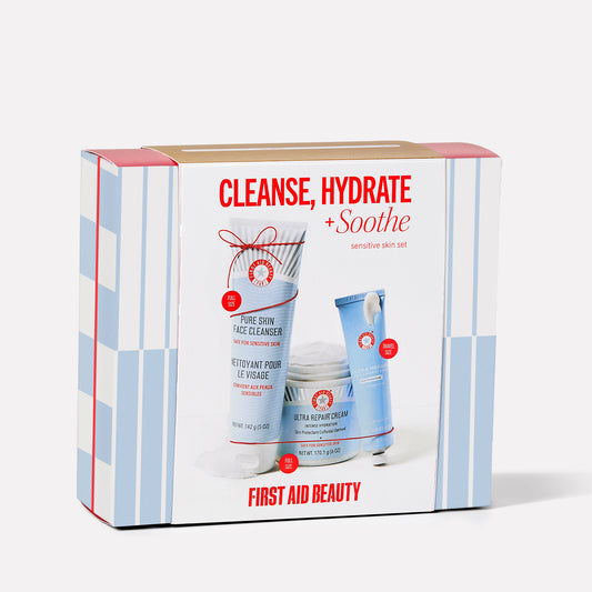 A skincare set labeled "Cleanse, Hydrate + Soothe" contains Pure Skin Face Cleanser and Ultra Repair Cream by First Aid Beauty. It’s designed for sensitive skin and includes full and travel sizes.