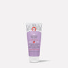 A cylindrical tube of "KP Bump Eraser Body Scrub" with lavender packaging stands upright. Text includes "With 10% AHA," "Safe for Sensitive Skin," "Fresh Strawberry," and "Net Wt. 56.7 g (2 oz)."